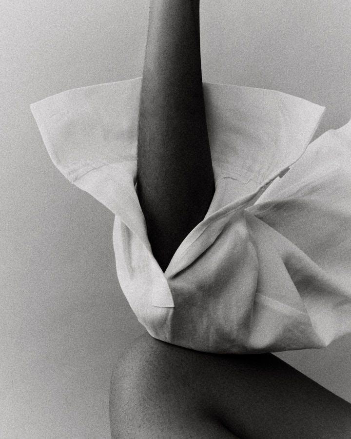 Fine art fashion photography exploring movement, fabric sculpture and minimalist editorial styling in monochrome